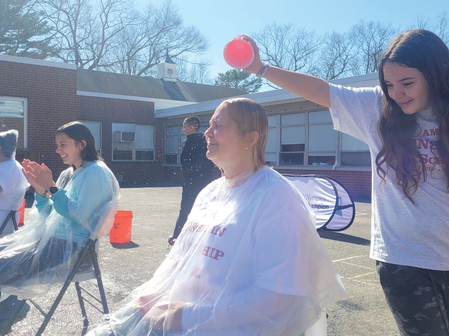 BROWN AVE. POUR: Students lined up to soak school staff members one cup, pitcher and bucket at a time, to raise money for Special Olympics Rhode Island. 